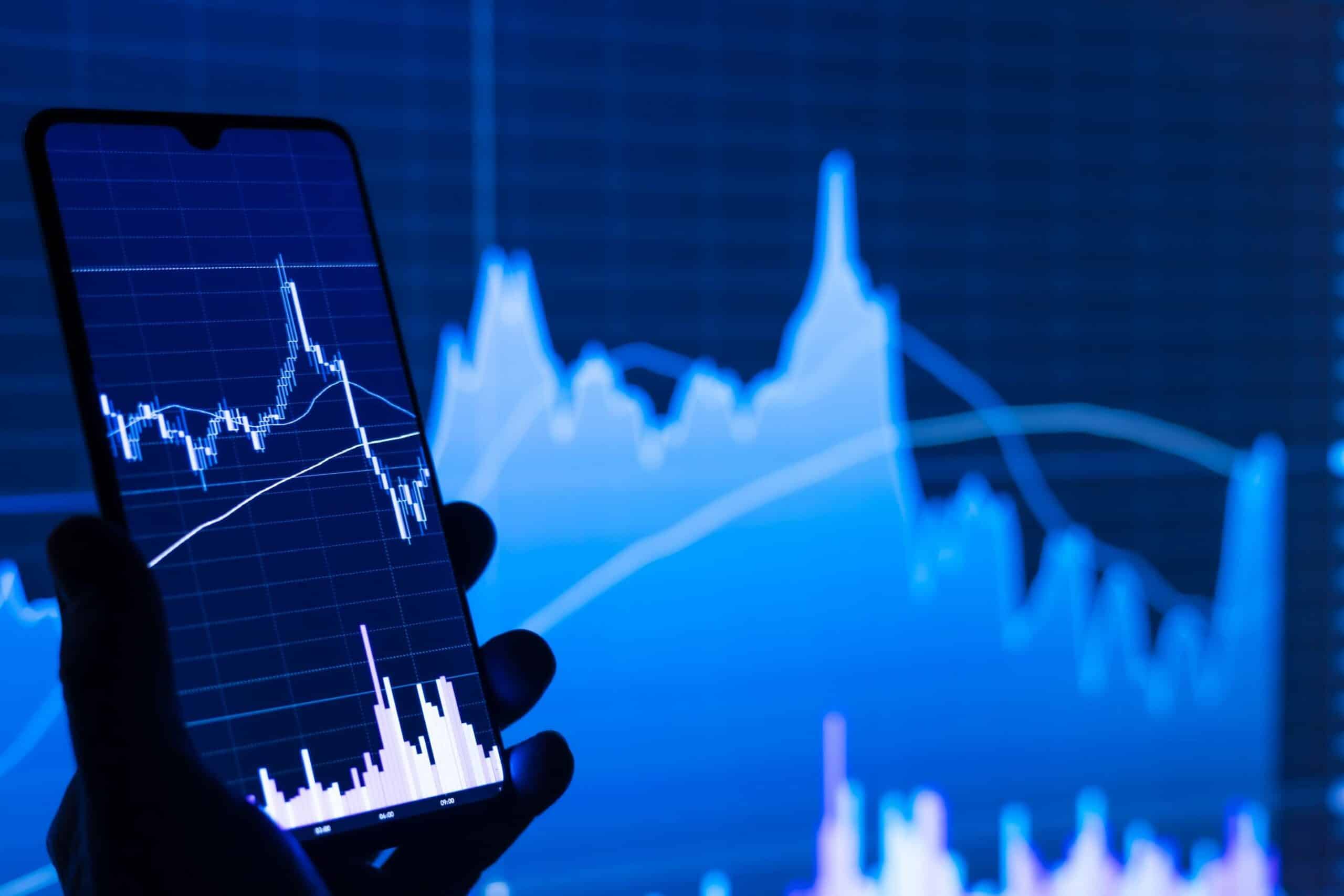 phone and screen and trading chart