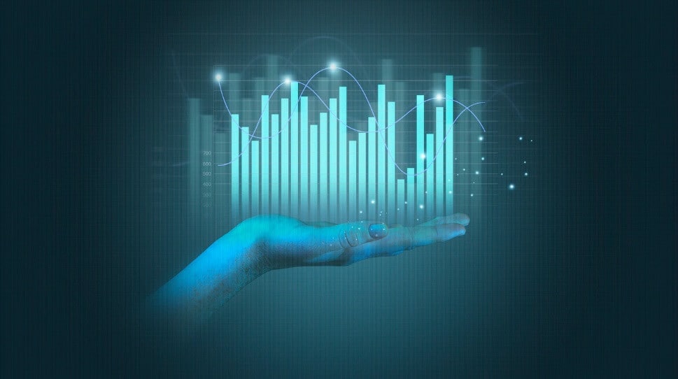 Hand holding light blue virtual trading chart