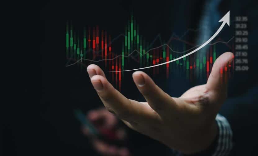 hand holding out a virtual red and green forex trade
