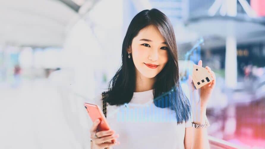 woman holding phone with virtual forex chart overaly